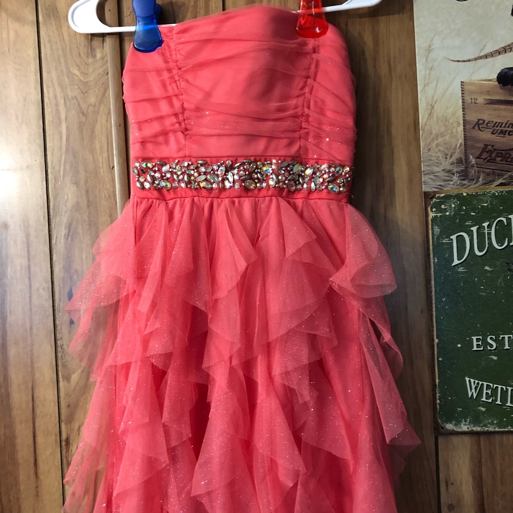 Sparkly, strapless dress with ruffles.